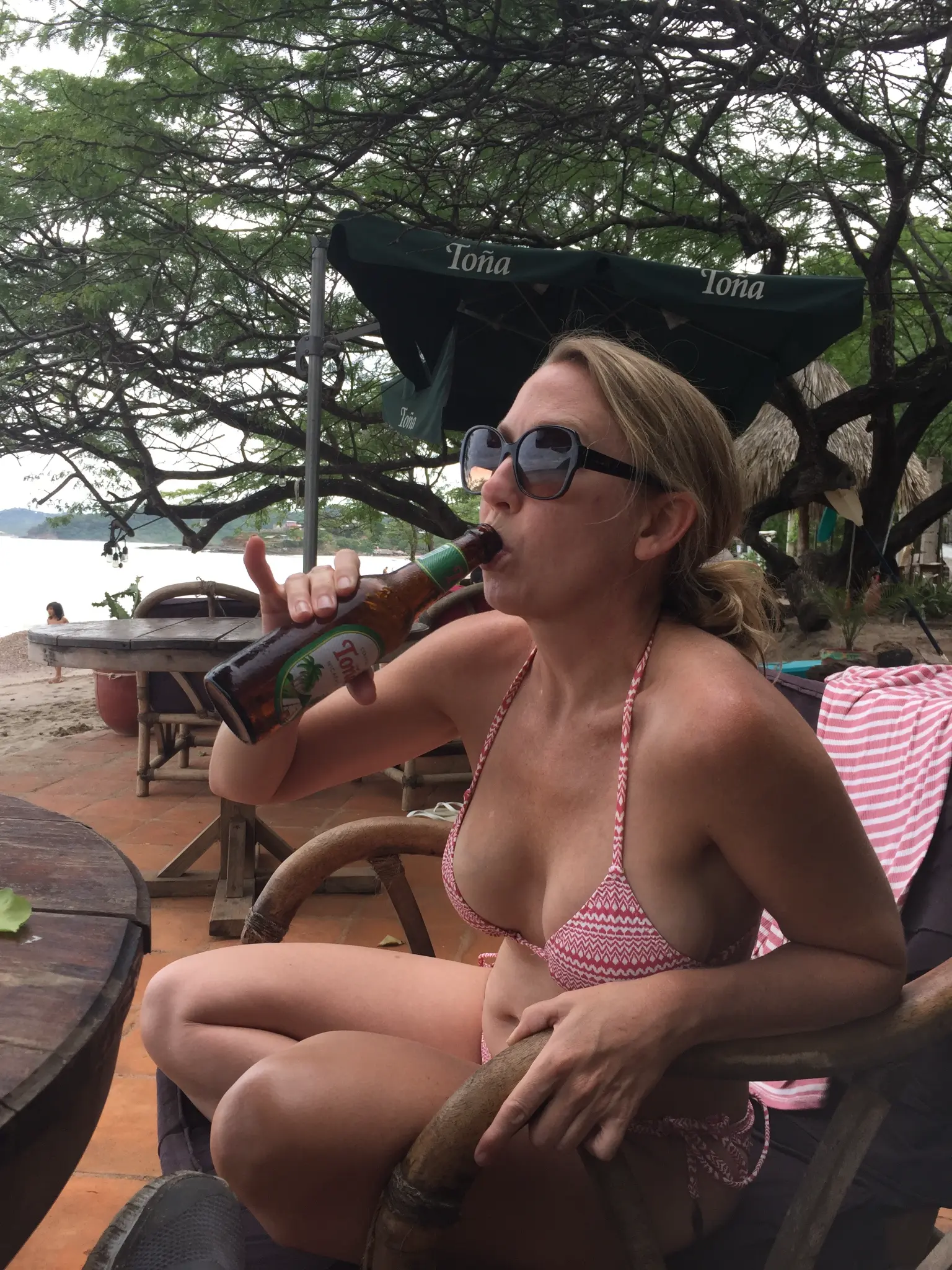 Drinking a cold Toña beer on the beach at San Juan del Sur Nicaragua under Toña umbrellas