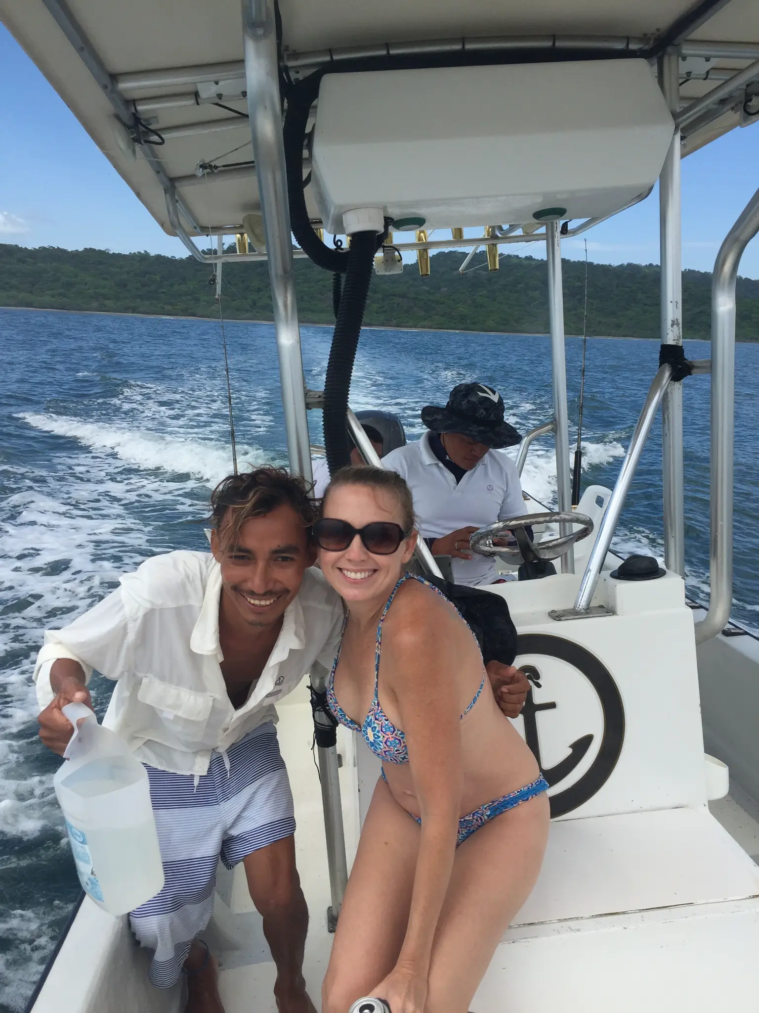 On the private boat ride to San Juan del Sur — smiling with the guide and captain on the Pacific