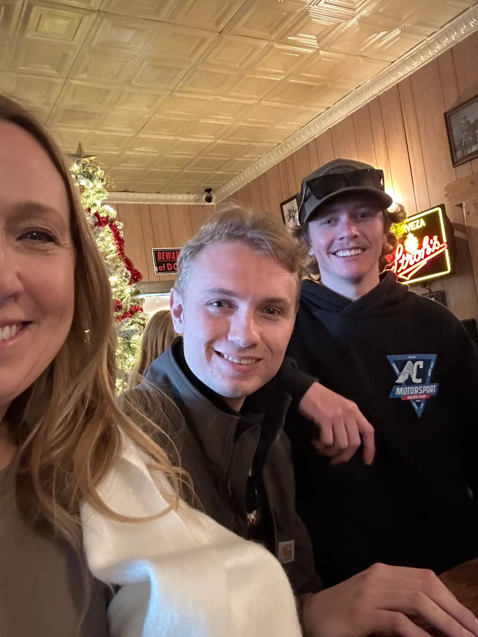 Kristen Shepherd and her two sons smiling inside the Red Dog Saloon on Mane Street in Pioneertown at Christmas